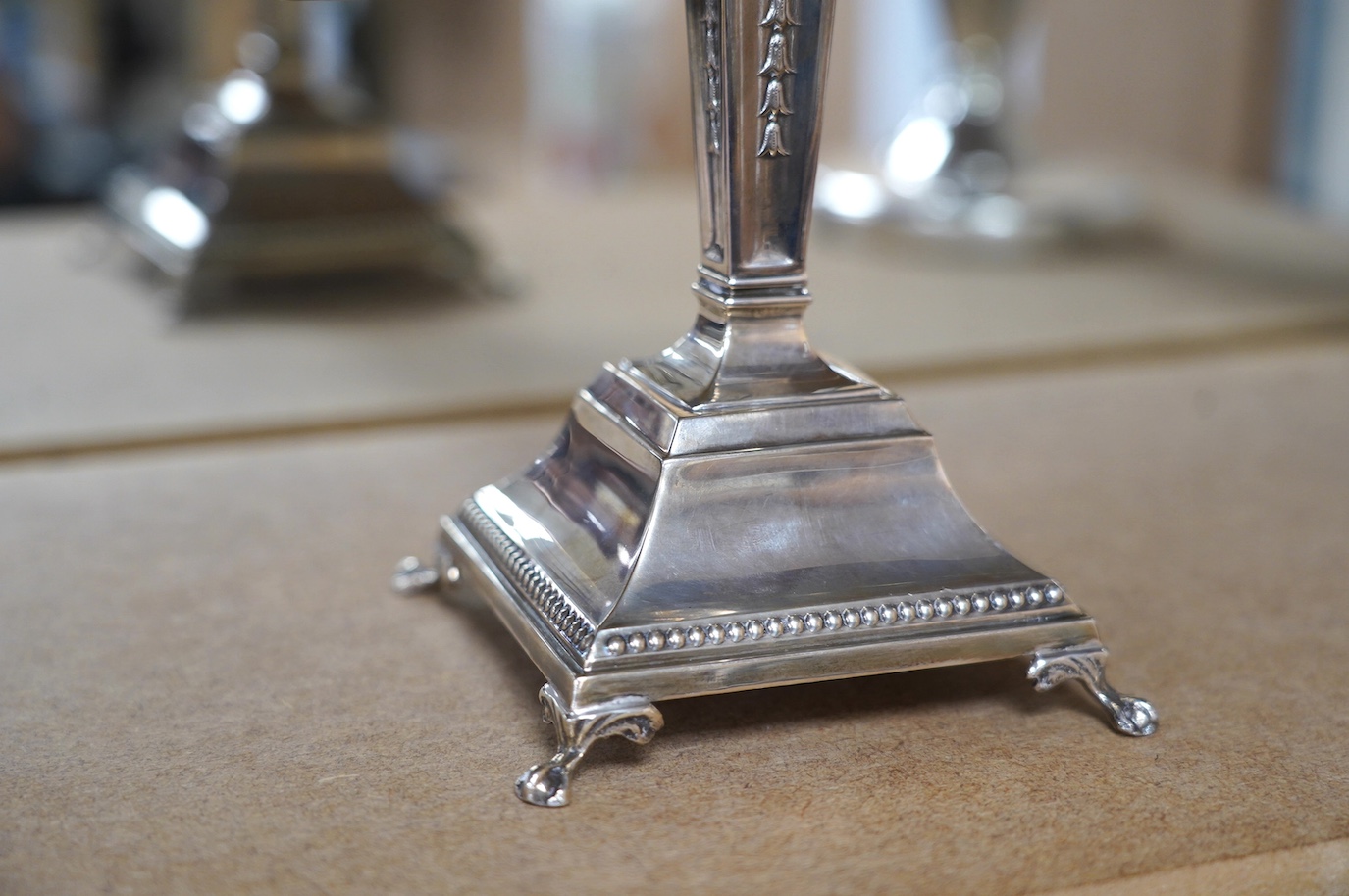 A modern silver Hanukkah Menorah, on a square base with four claw and ball feet, by Alexander Smith, Birmingham, 1967, height 27.6cm, weighted. Condition - fair to good